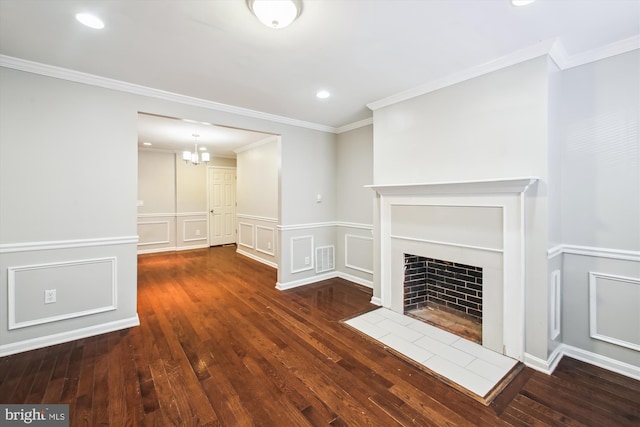 unfurnished living room with ornamental molding, a tiled fireplace, and dark hardwood / wood-style flooring