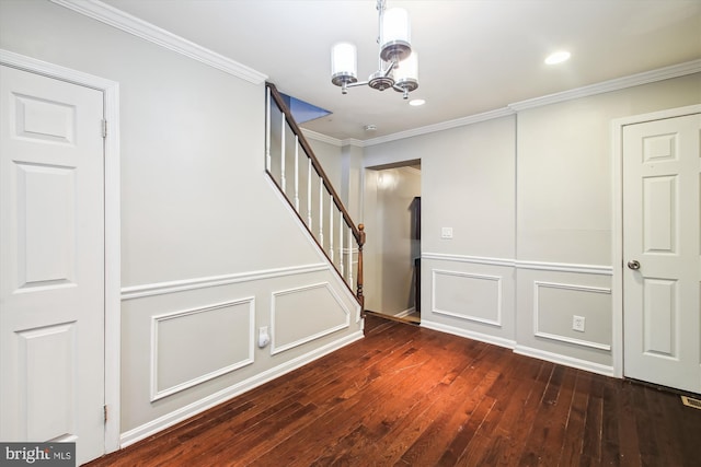 staircase with crown molding, hardwood / wood-style floors, and an inviting chandelier