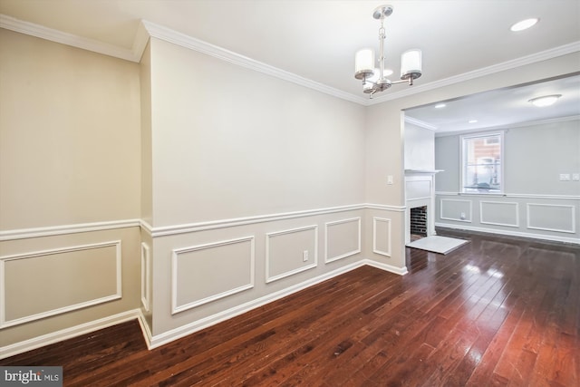 empty room with ornamental molding, dark wood-type flooring, and an inviting chandelier