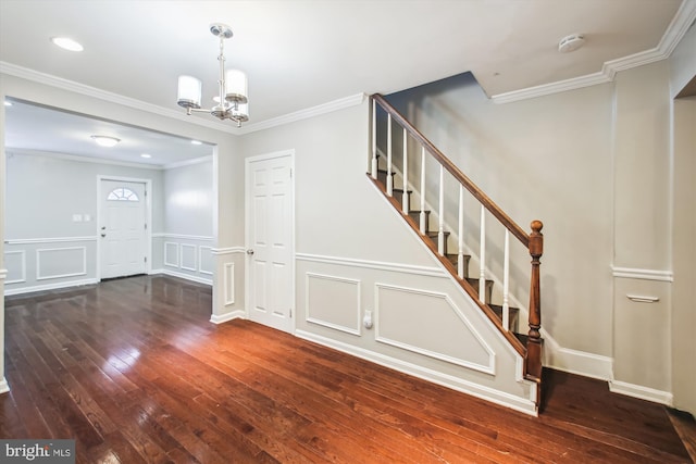 interior space with wood-type flooring, ornamental molding, and an inviting chandelier