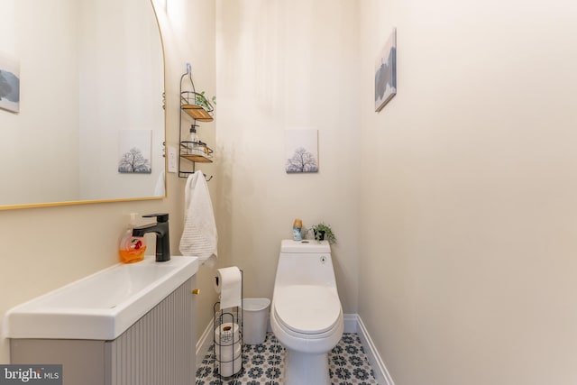 bathroom featuring toilet and vanity