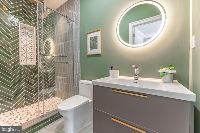 bathroom with a shower with door, toilet, vanity, and tile patterned flooring