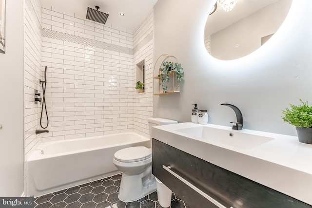 full bathroom with tiled shower / bath combo, toilet, and vanity