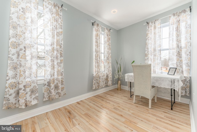 home office with light hardwood / wood-style floors