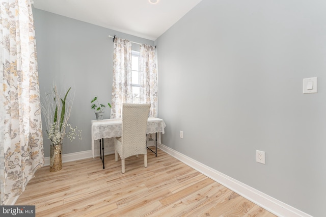 home office featuring light hardwood / wood-style floors and lofted ceiling