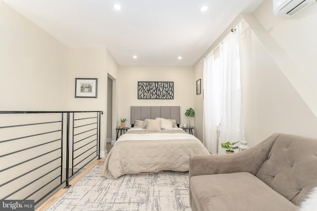 bedroom featuring an AC wall unit and light wood-type flooring