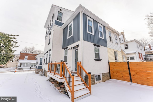 view of snow covered rear of property