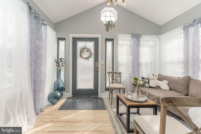 entryway with vaulted ceiling and hardwood / wood-style flooring