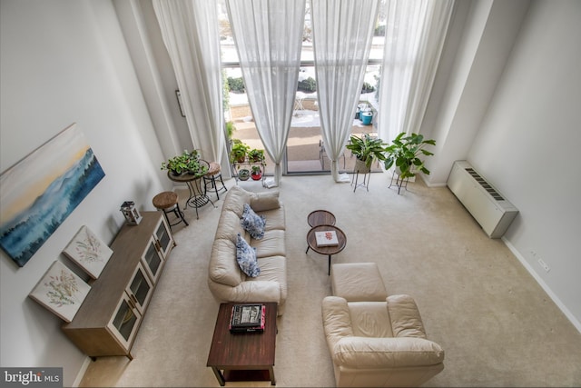 carpeted living room with an AC wall unit