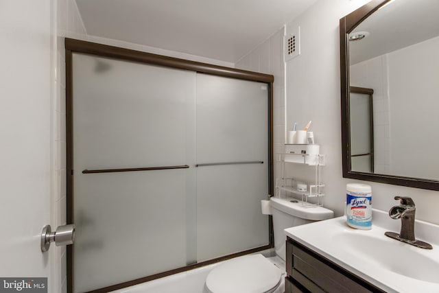 full bathroom featuring toilet, vanity, and enclosed tub / shower combo