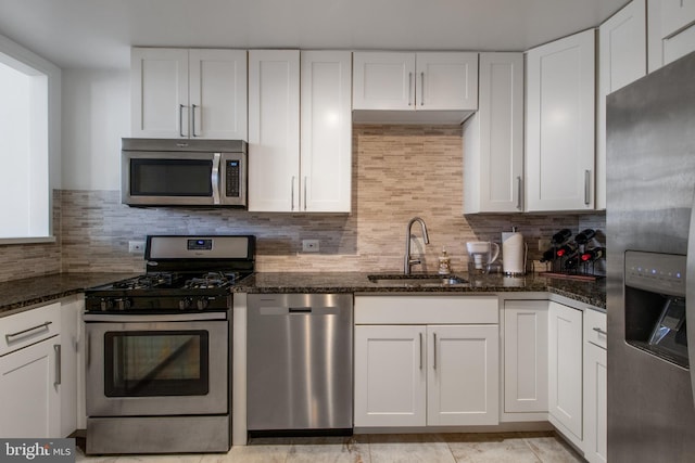 kitchen with white cabinets, appliances with stainless steel finishes, and sink