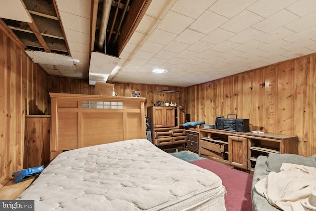 bedroom with wood walls