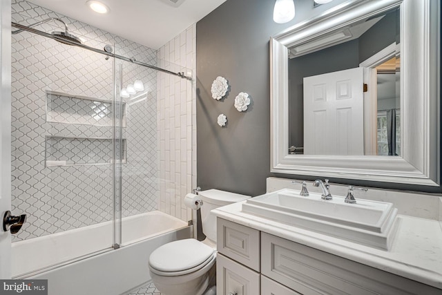 full bathroom with vanity, shower / bath combination with glass door, and toilet