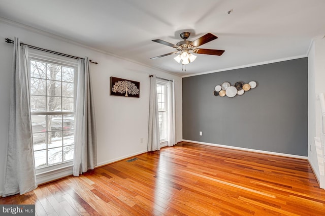 spare room with ceiling fan, light hardwood / wood-style flooring, and crown molding