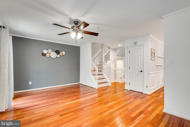 spare room featuring crown molding, light wood-type flooring, and ceiling fan