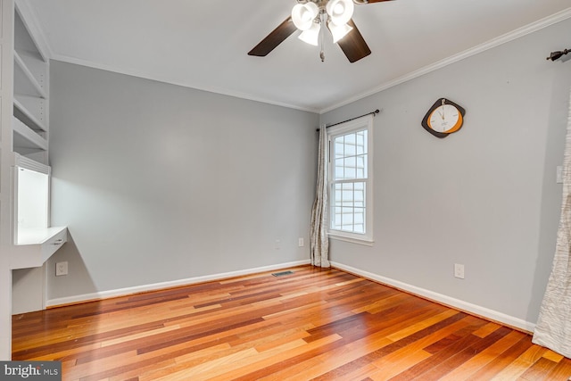 spare room with ornamental molding, ceiling fan, and light hardwood / wood-style flooring