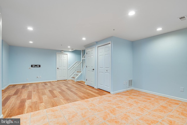 basement featuring light tile patterned floors