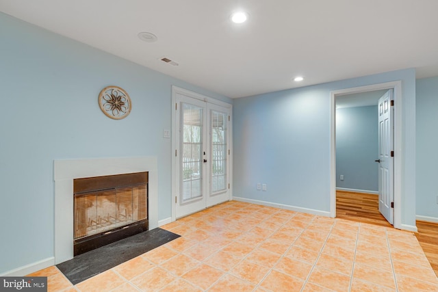 living room featuring french doors and light tile patterned floors