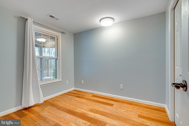 spare room with wood-type flooring