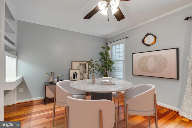 dining room featuring ceiling fan, crown molding, and light hardwood / wood-style floors