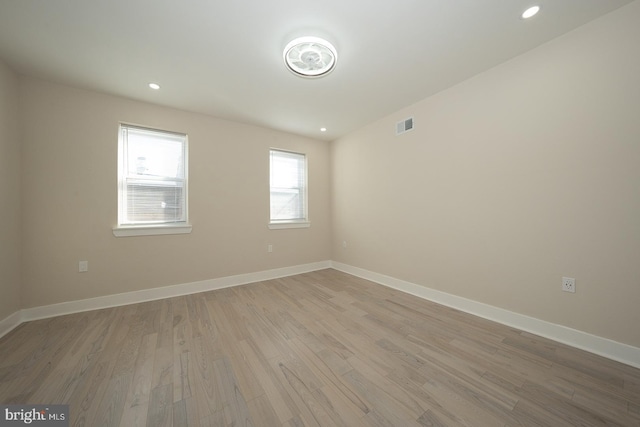 empty room with light hardwood / wood-style flooring