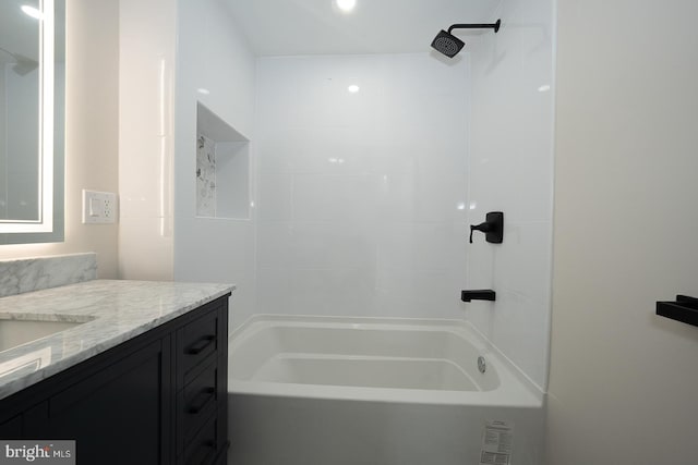 bathroom with washtub / shower combination and vanity