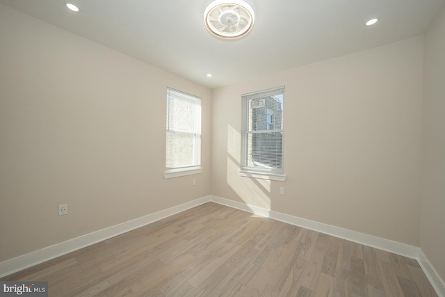 spare room with light hardwood / wood-style flooring