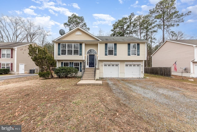 raised ranch featuring central AC and a garage