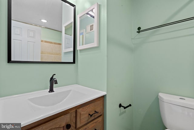 bathroom with toilet and vanity