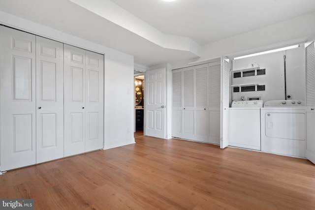 laundry room with light hardwood / wood-style floors and separate washer and dryer