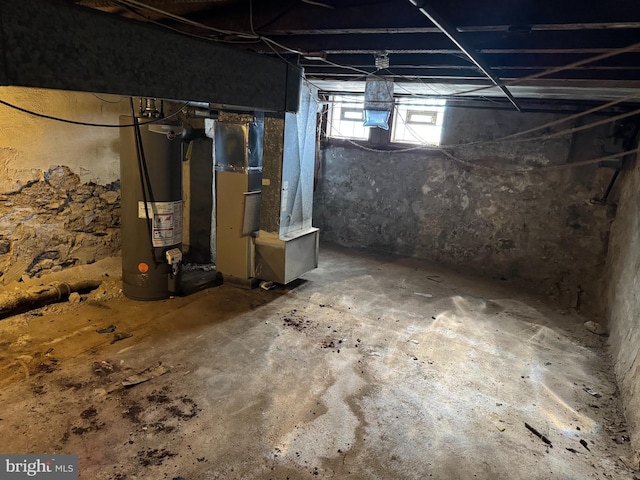 basement featuring water heater and heating unit