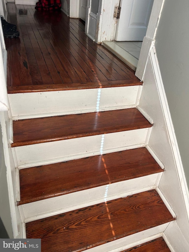 stairs featuring wood-type flooring