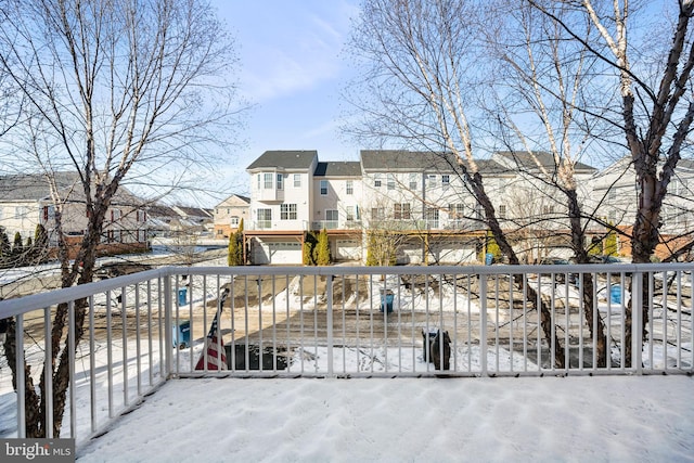 view of snow covered back of property