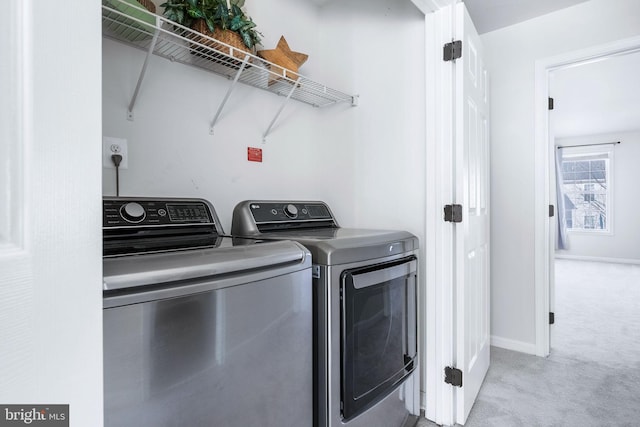 laundry area featuring light carpet and independent washer and dryer