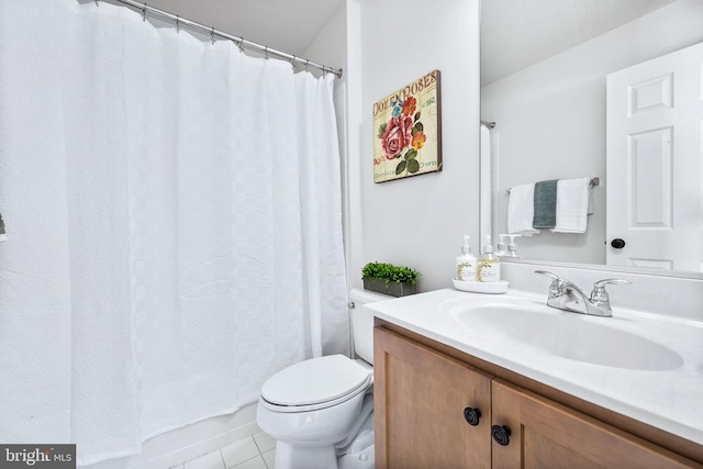 bathroom featuring toilet, tile patterned floors, and vanity