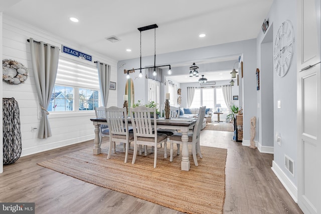 dining space featuring plenty of natural light, a chandelier, and hardwood / wood-style flooring