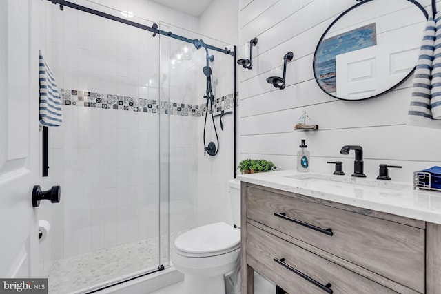 bathroom with toilet, vanity, an enclosed shower, and wooden walls