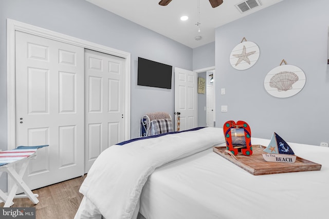 bedroom with ceiling fan, hardwood / wood-style floors, and a closet