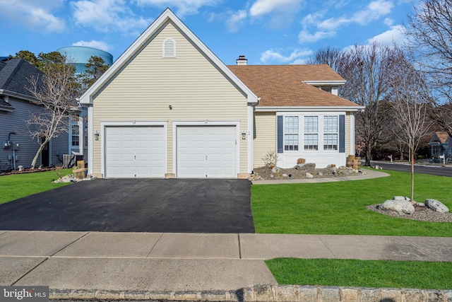 view of front of house featuring a garage and a front yard