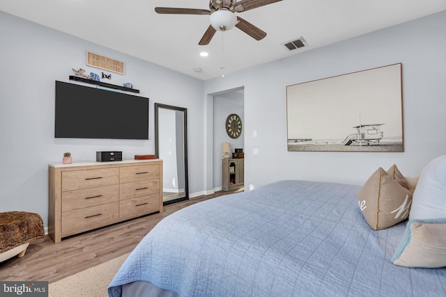 bedroom with ceiling fan and light wood-type flooring