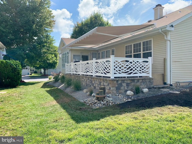 view of property exterior featuring a lawn