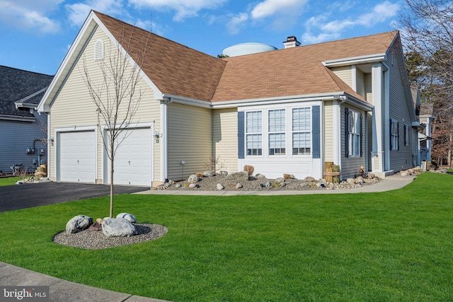 view of front facade with a garage and a front lawn