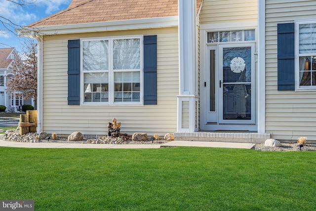 doorway to property featuring a yard