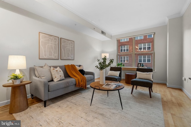 sitting room featuring light hardwood / wood-style flooring and crown molding