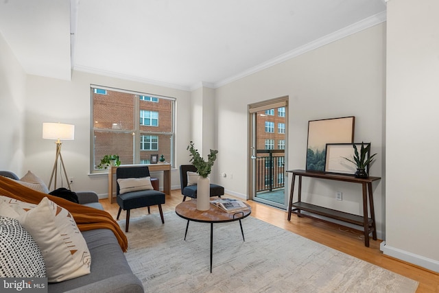 living room with crown molding and light hardwood / wood-style flooring