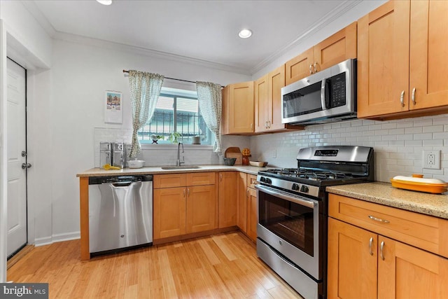 kitchen featuring light wood-type flooring, appliances with stainless steel finishes, crown molding, and sink