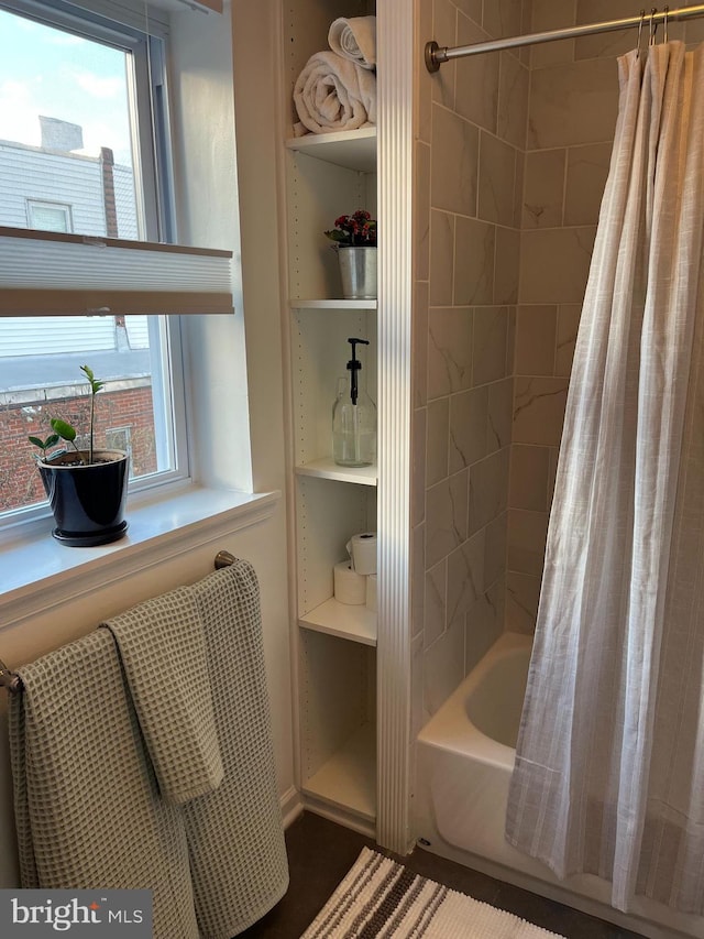 bathroom with a healthy amount of sunlight and shower / bath combo