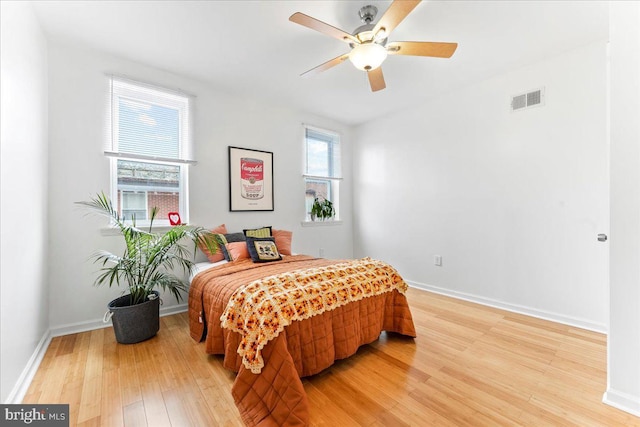 bedroom with ceiling fan and hardwood / wood-style flooring