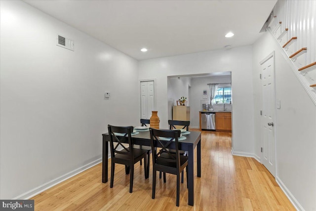 dining space featuring light wood-type flooring