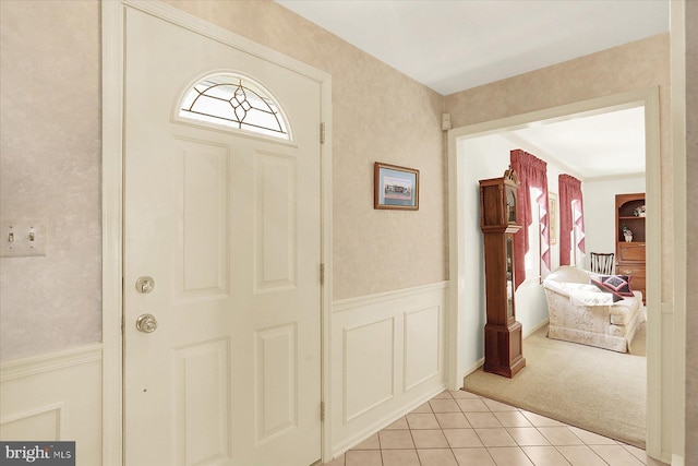 foyer entrance featuring light colored carpet